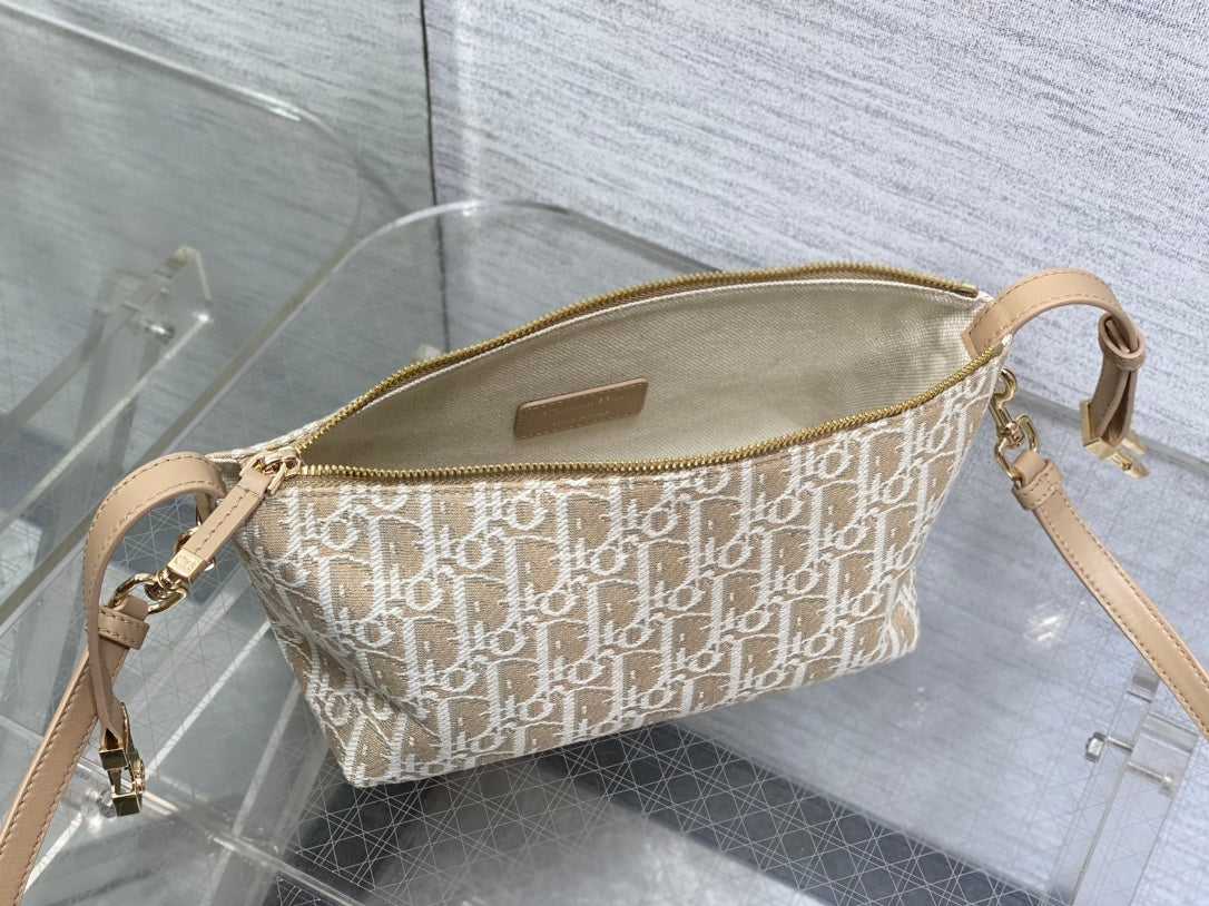 Dior monogram mini bag with gold-tone zipper and crossbody strap, leather patch