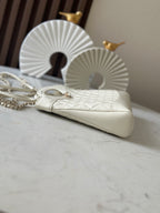 Chanel cream handbag with quilted front, chain strap, and gold-tone handle hardware