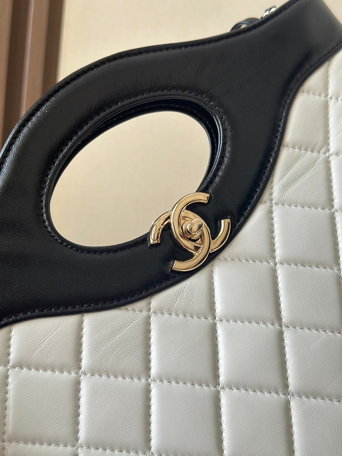 Chanel quilted handbag handle ring detail with gold clasp hardware