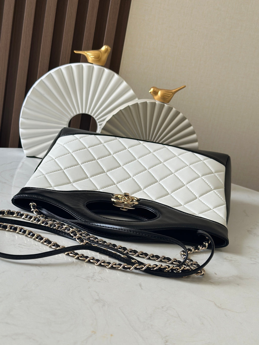 Chanel quilted handbag with flap and gold clasp, chain strap on the front