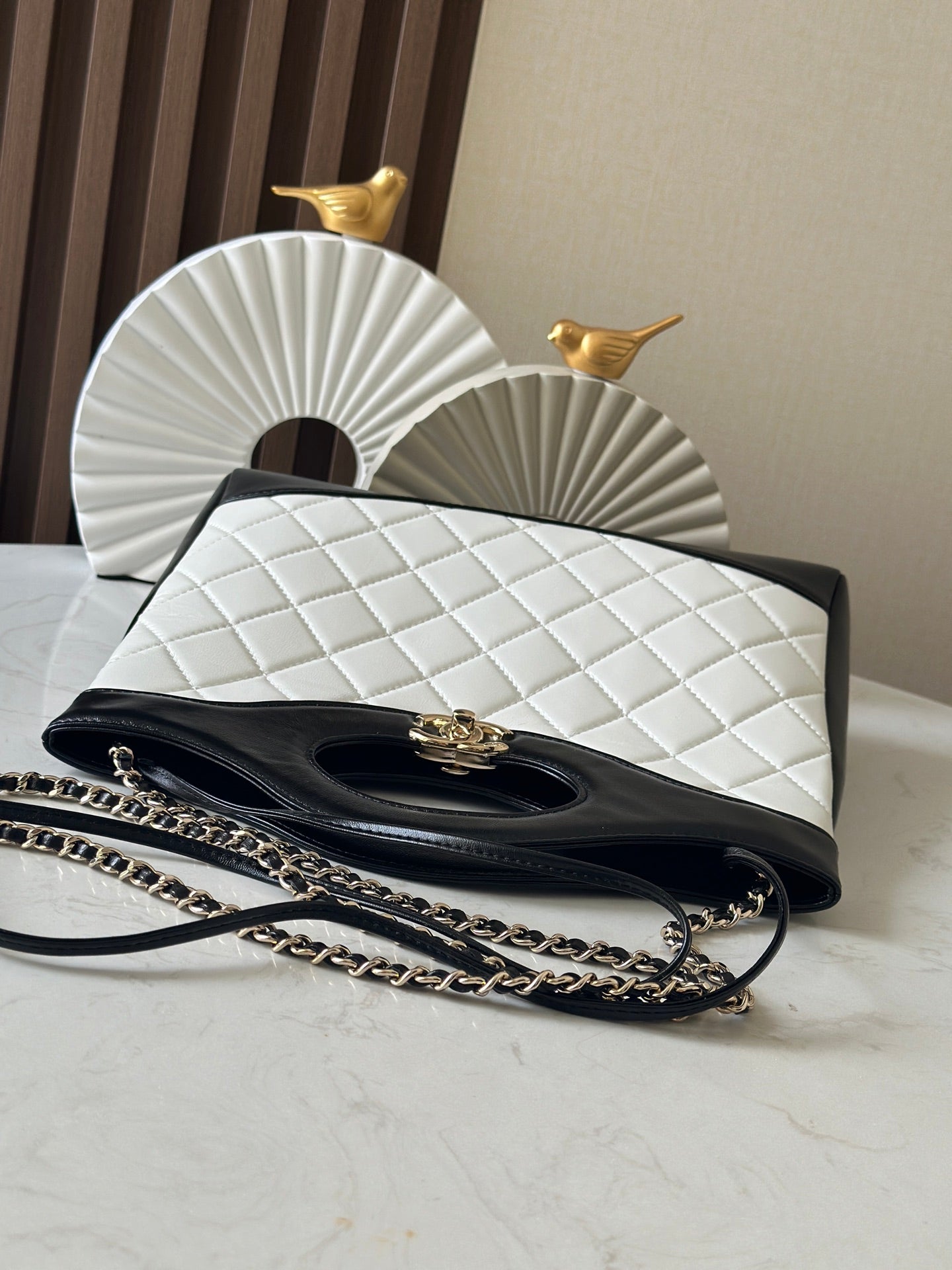 Chanel quilted handbag with flap and gold clasp, chain strap on the front
