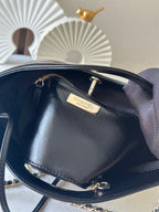 Chanel handbag interior close-up with brand label and gold zipper pull