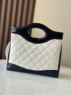 Chanel quilted handbag with light body and dark trim, front view