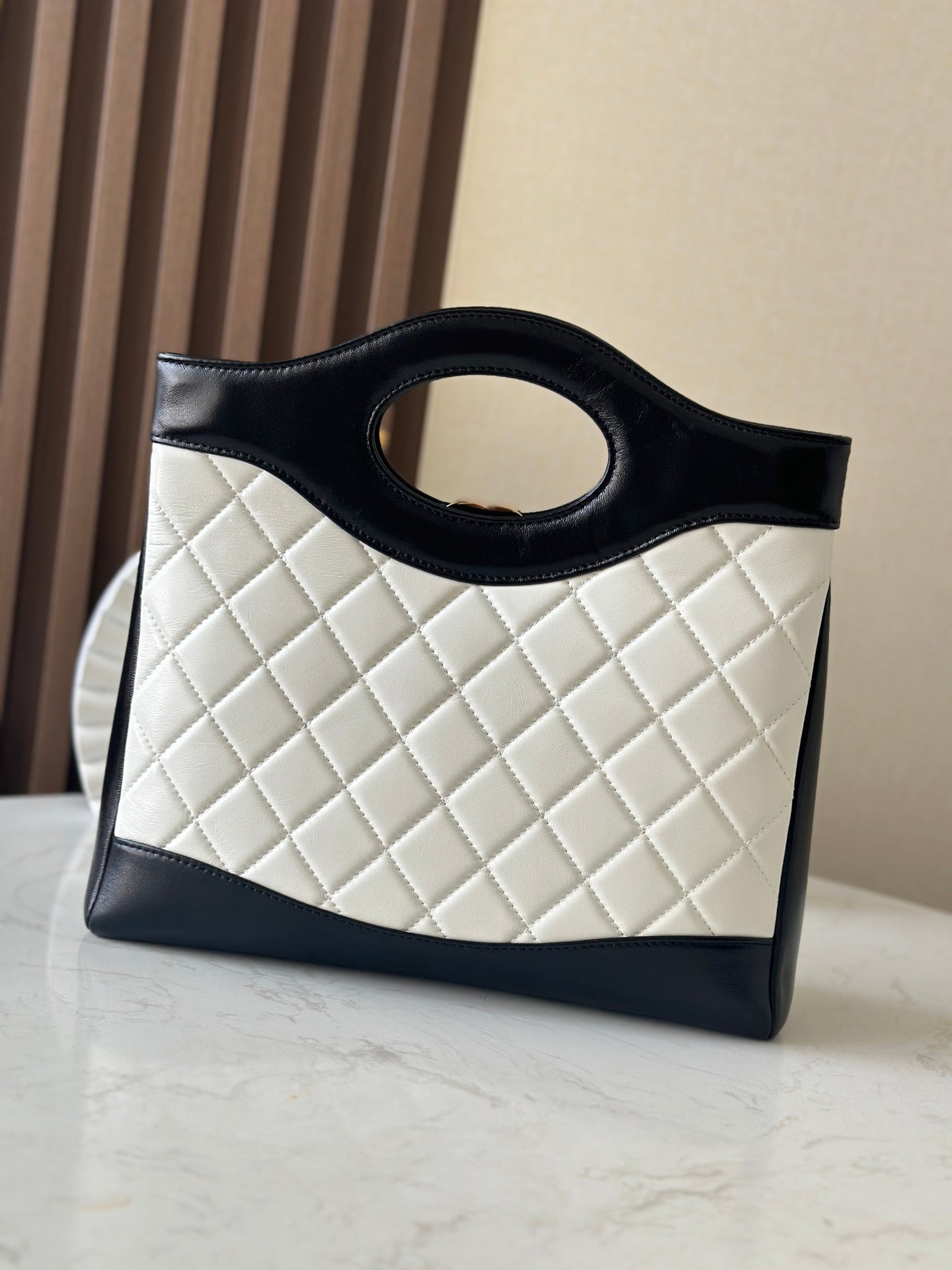 Chanel quilted handbag with light body and dark trim, front view