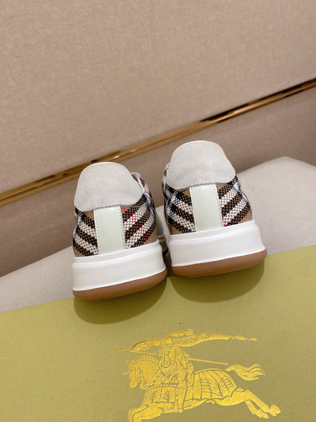 White low-top sneakers with plaid heel inserts and white pull-tab