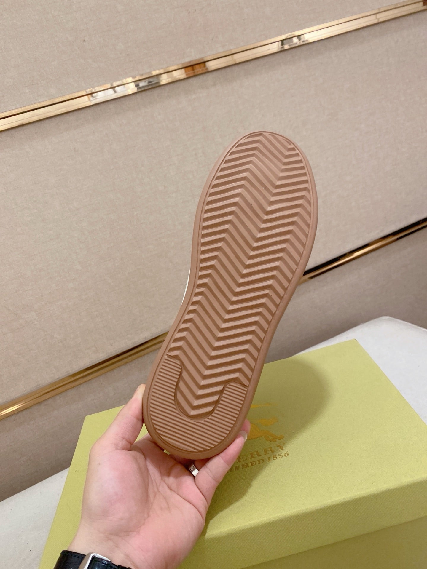 Brown rubber sneaker outsole with chevron tread pattern