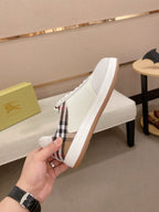 White sneakers with plaid side panel, lace-up vamp, and gum rubber sole