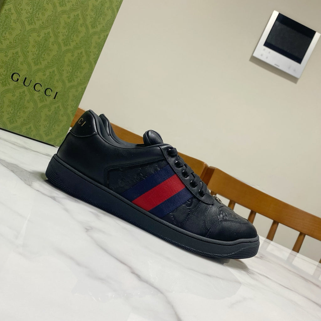 Gucci unisex sneakers, side view; black with blue-and-red stripe and lace-up closure.