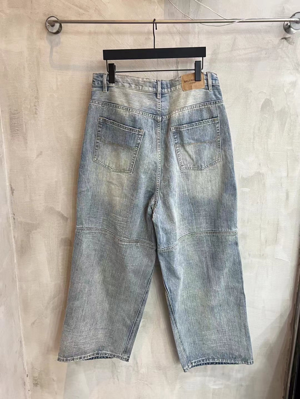 Light blue denim pants with two back pockets and waistband belt loops