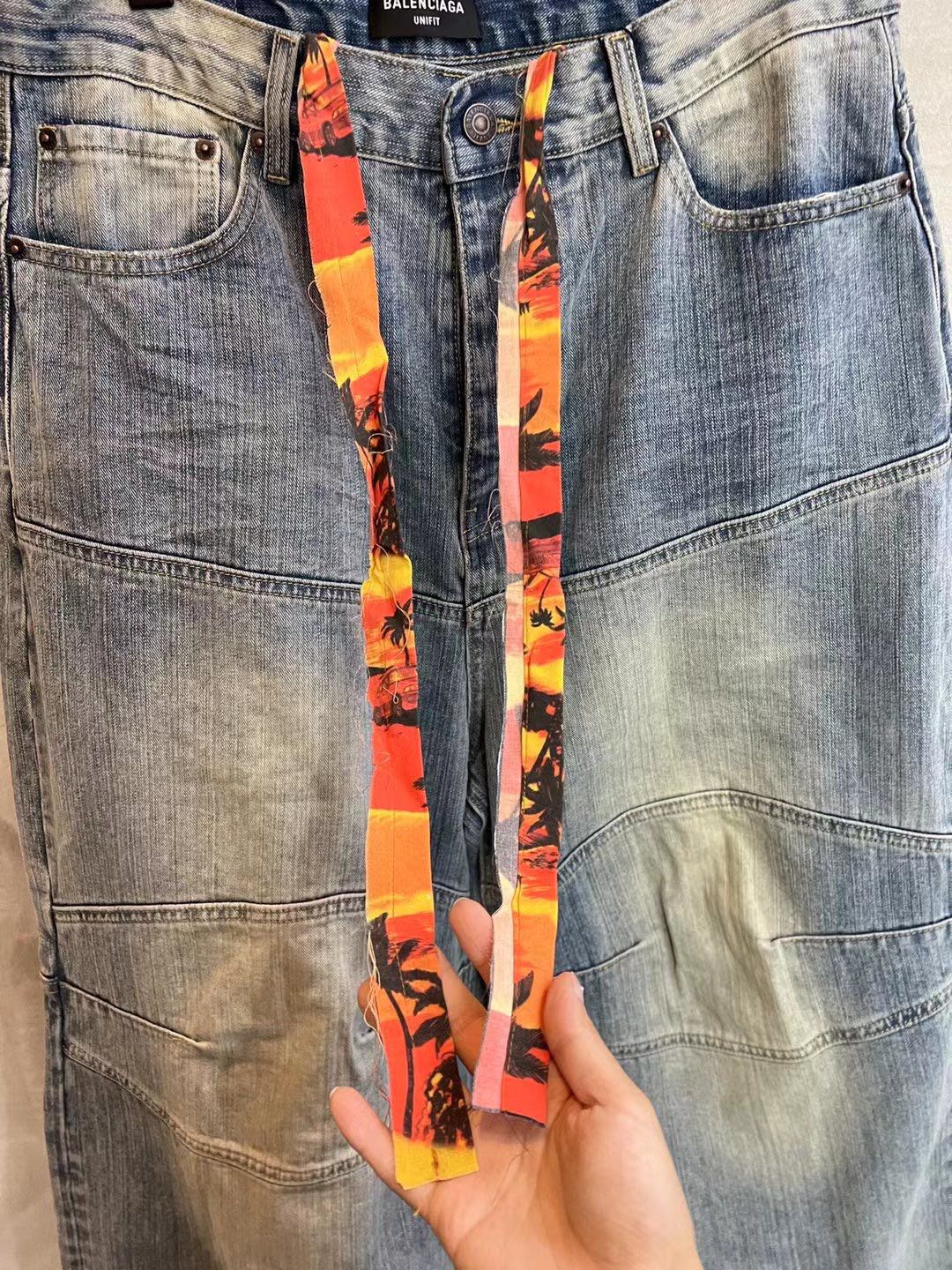 Light blue denim pants front with colorful ribbon and front pockets