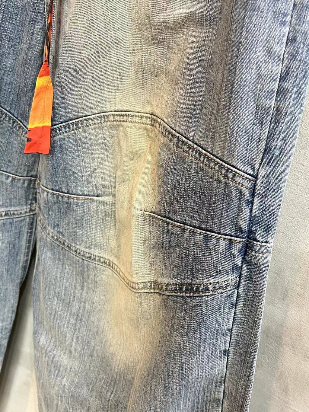 Light blue denim pants back with stitched pocket and worn wash details