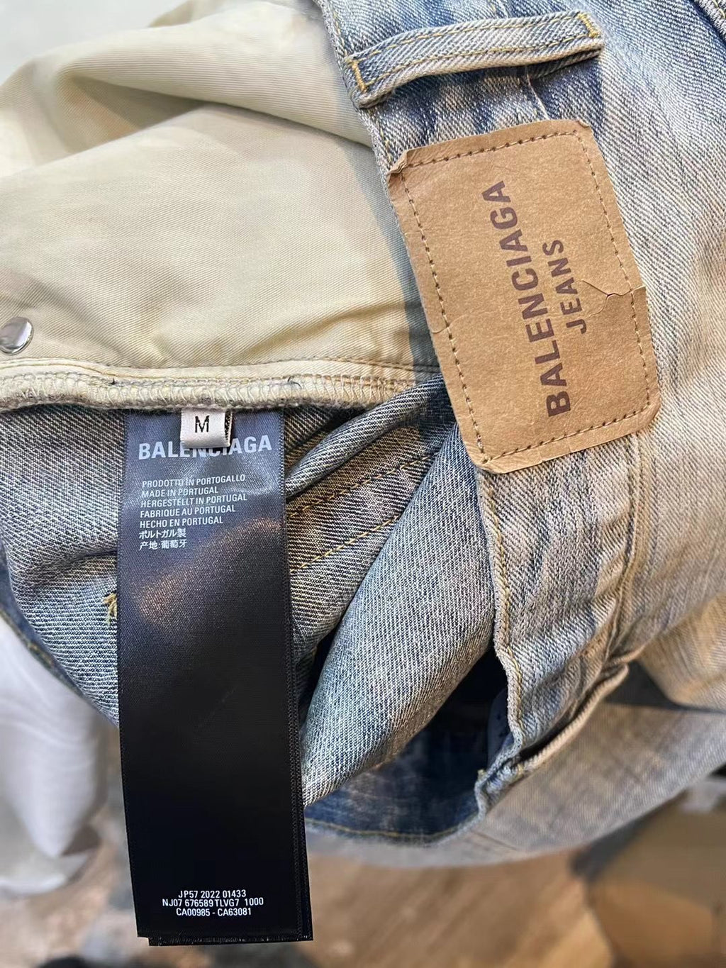 Light blue denim pants with Balenciaga leather logo patch and fabric size label