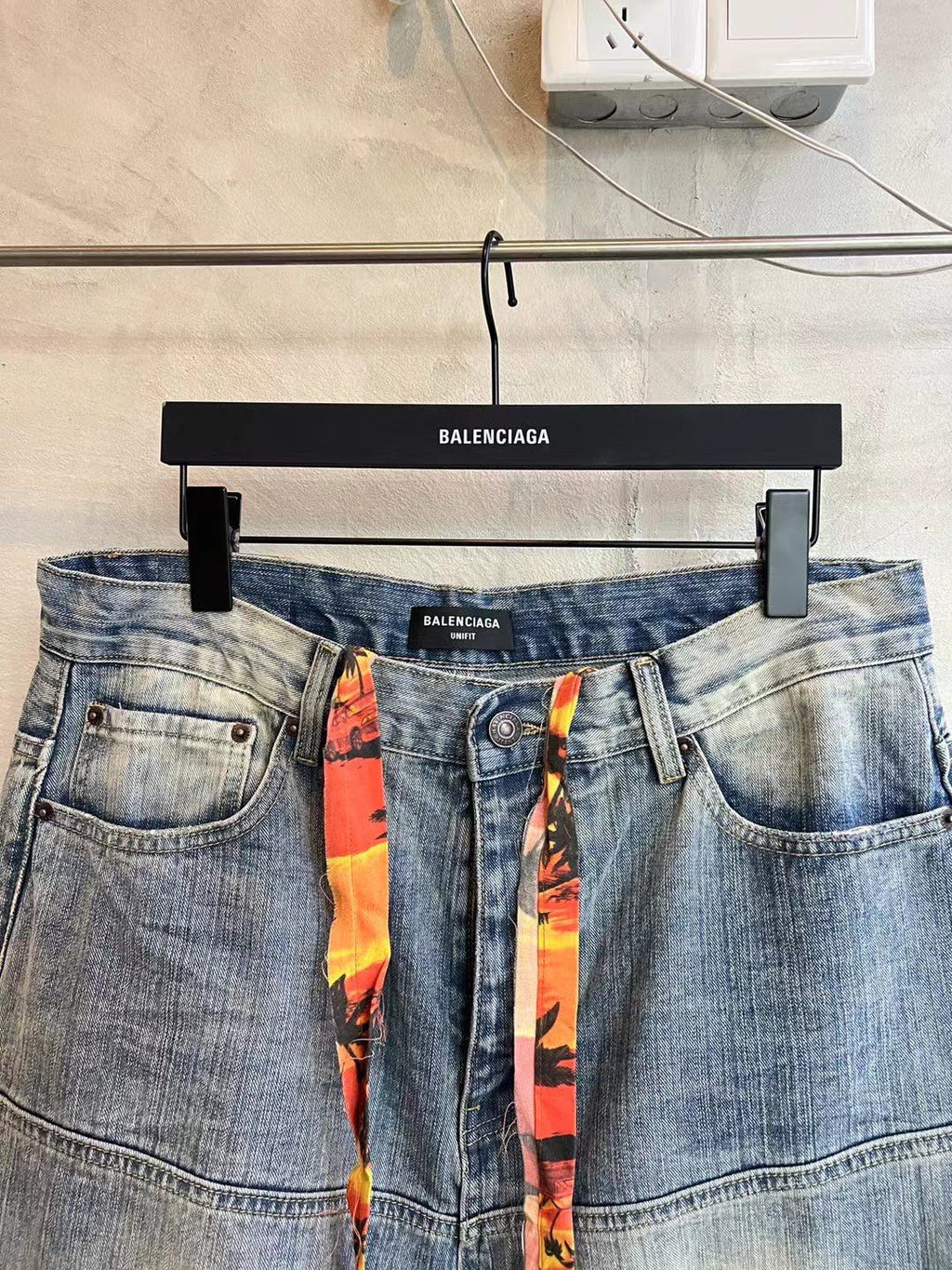 Light blue denim pants with waist logo label and colorful ribbon drawstring