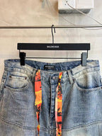 Light blue denim pants with waist logo label and colorful ribbon drawstring