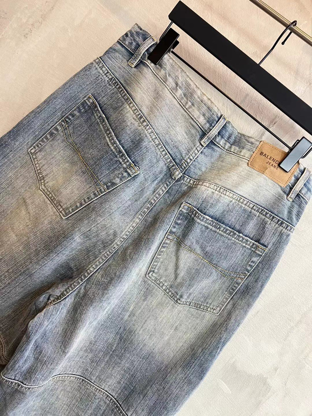Light blue denim pants with square back pocket and wide-leg drape