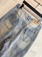 Light blue denim pants with square back pocket and wide-leg drape