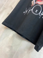 Balenciaga black T-shirt sleeve with partial MYCELH circular graphic print