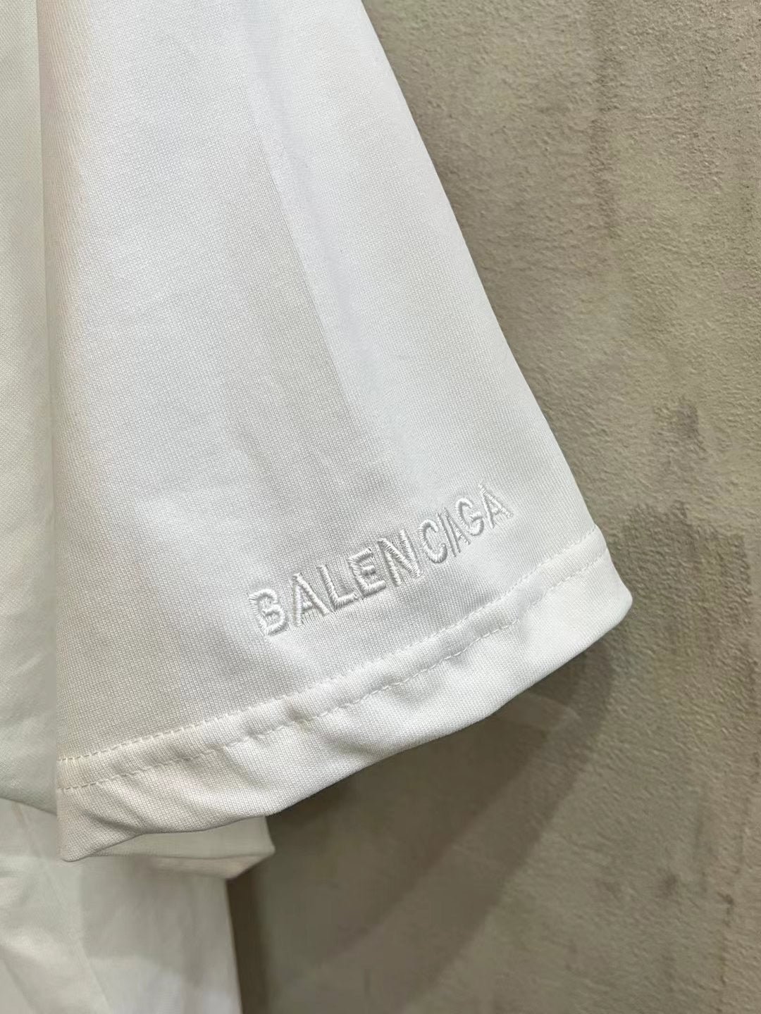 White Balenciaga T-shirt hem with small BALENCIAGA logo text