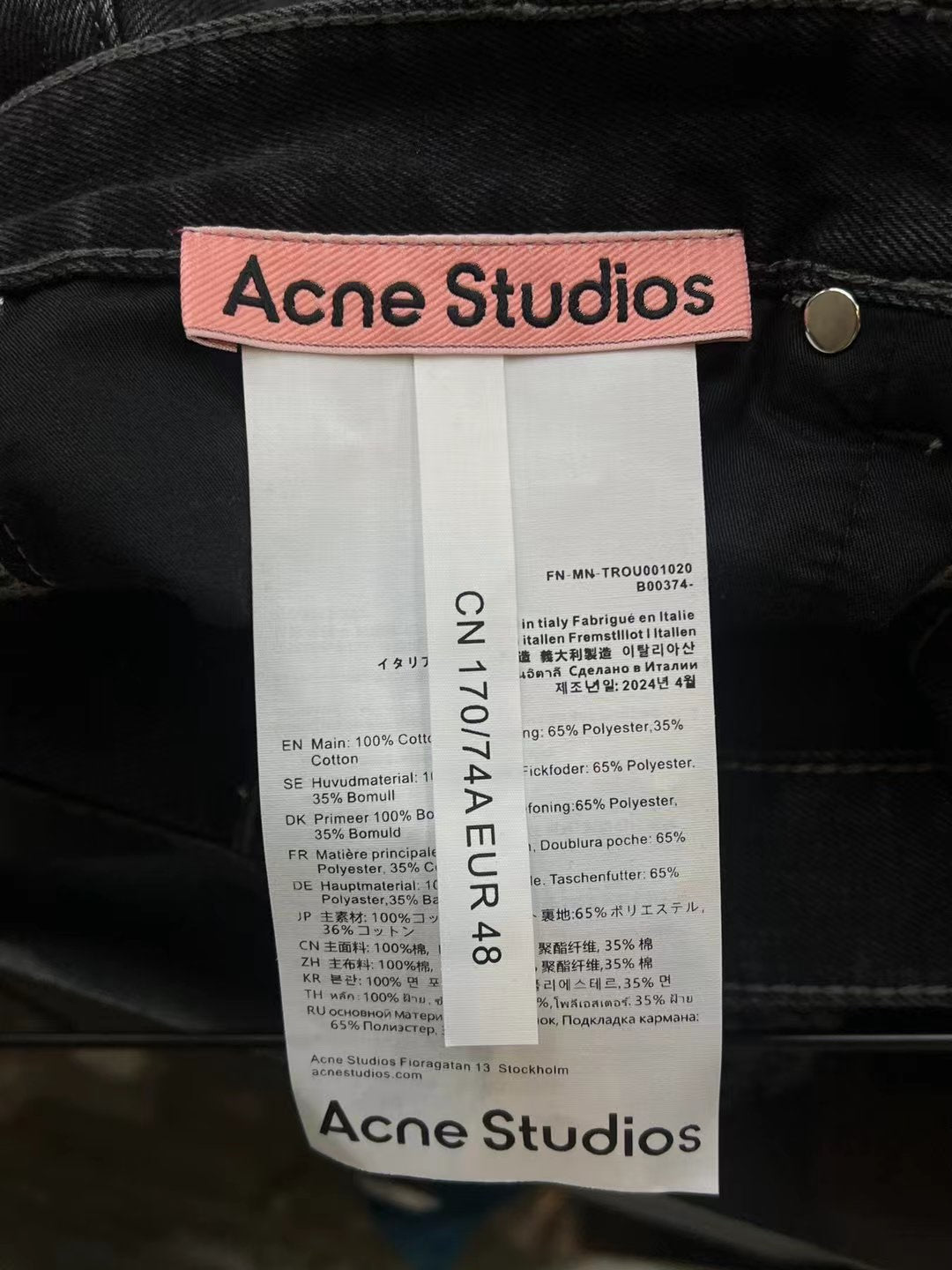 Dark denim shorts interior care label and button at waistband area