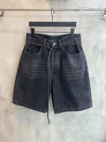Dark wash denim shorts with belt loops, front pockets, and tied waist drawstring