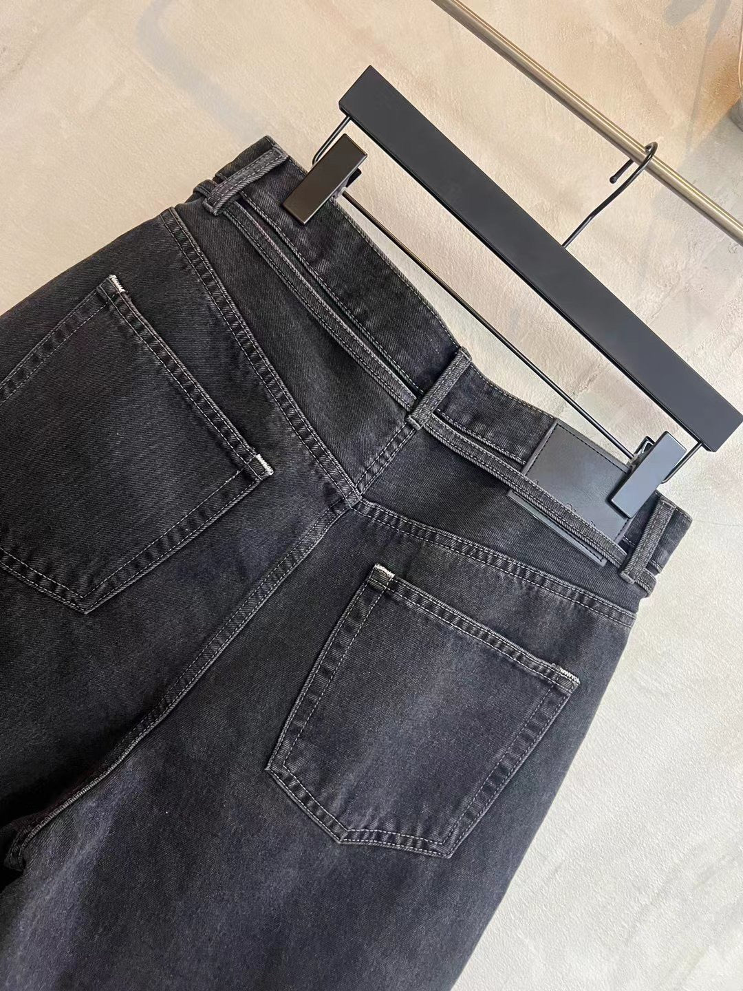 Dark wash denim shorts angled view with belt loops and front flap pockets