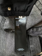 Denim pants close-up of waistband and inner care label, black and gray denim.