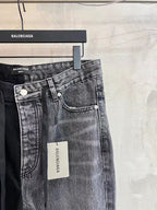 Denim pants with belt loops and front buttons, gray wash, wide leg.