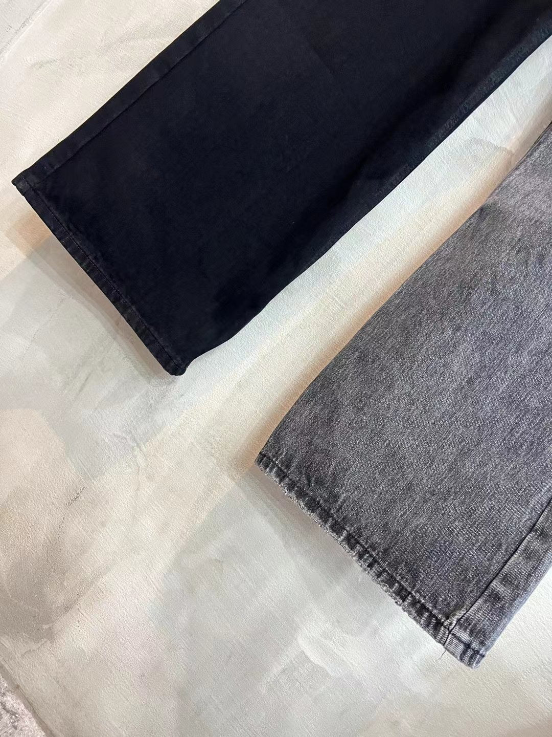 Wide-leg denim pants, dark fabric with straight hem.
