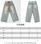 Light blue denim pants shown with size chart table overlay