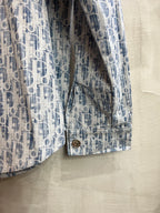 Blue-and-white patterned long-sleeve shirt cuff with stitched hem and button