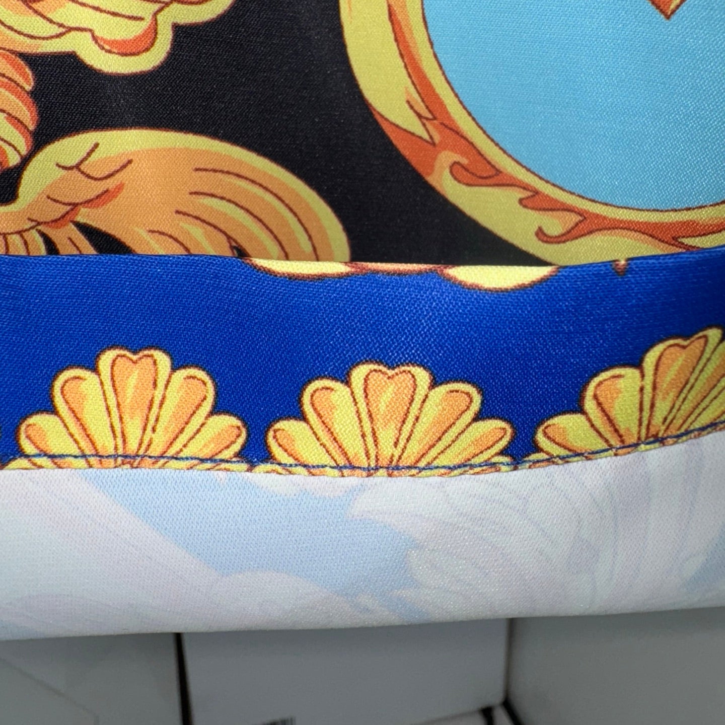 Versace shorts hem and waistband trim, blue edge with gold shell print on white fabric