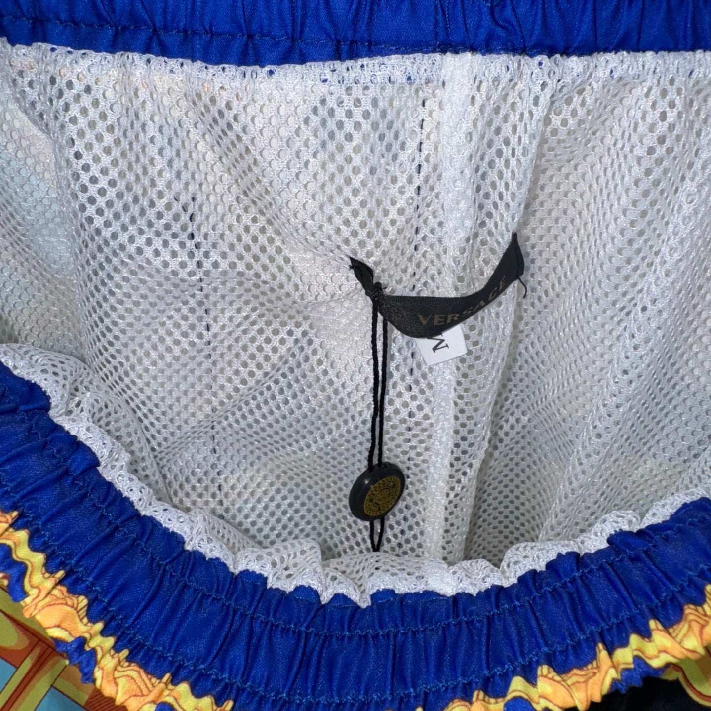 Versace sheer shorts interior with blue elastic waistband and size tag at front