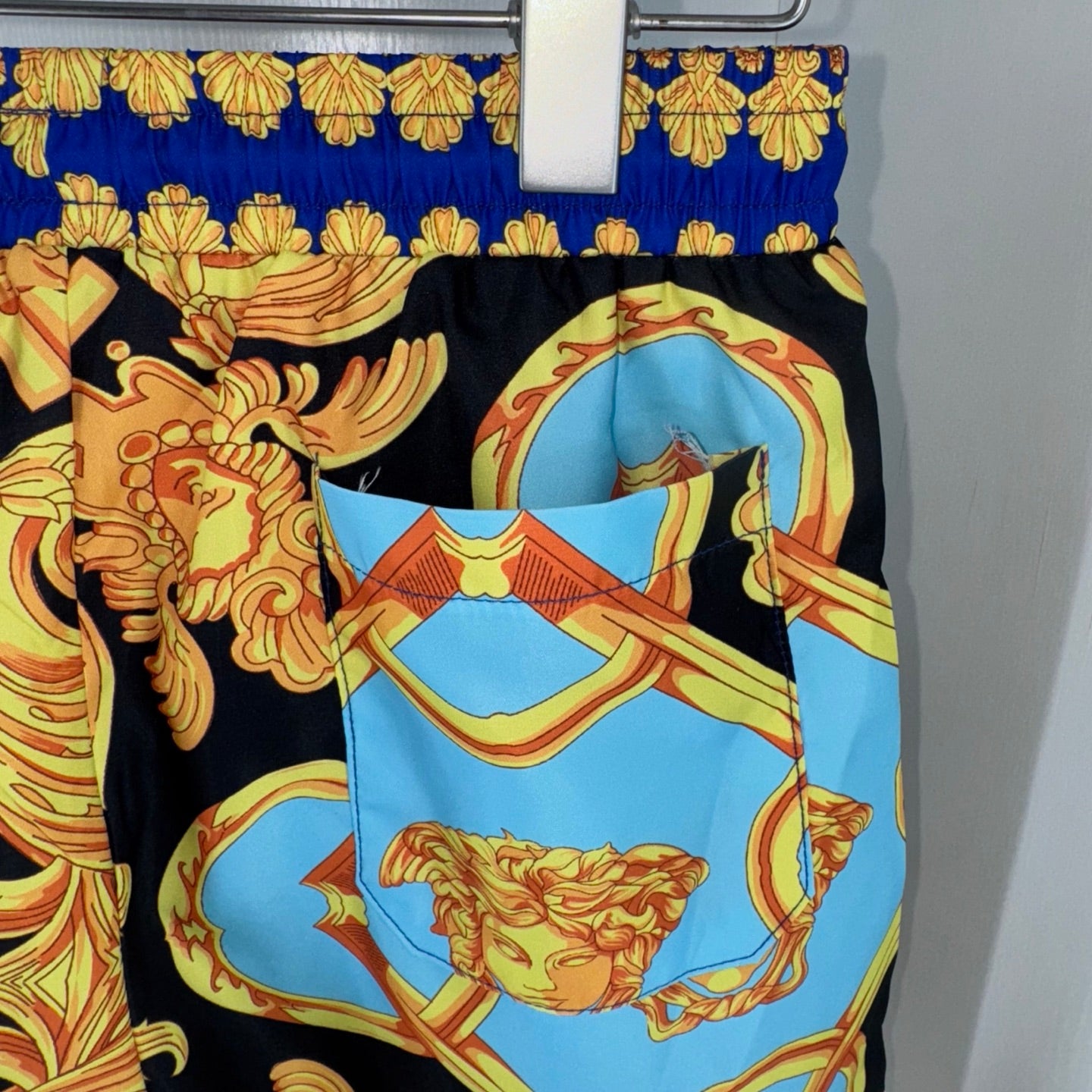 Versace baroque print shorts with light-blue front panel and black gold motifs