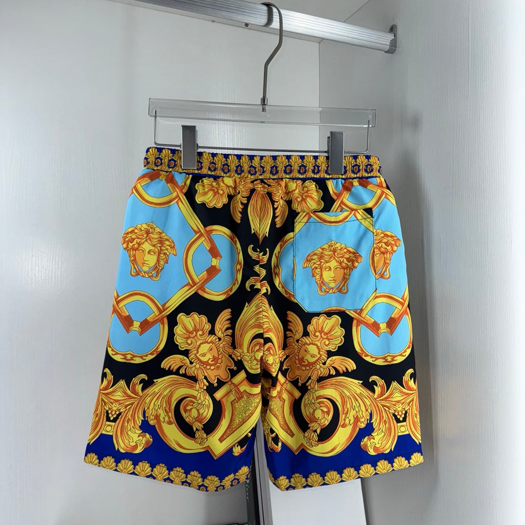Versace printed shorts on hanger, black base with blue panels and gold baroque motifs