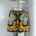 Versace shorts with bold black, blue and gold baroque medallion print, drawstring waist