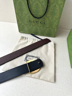 Brown leather belt with gold-toned circular buckle and adjustable strap end