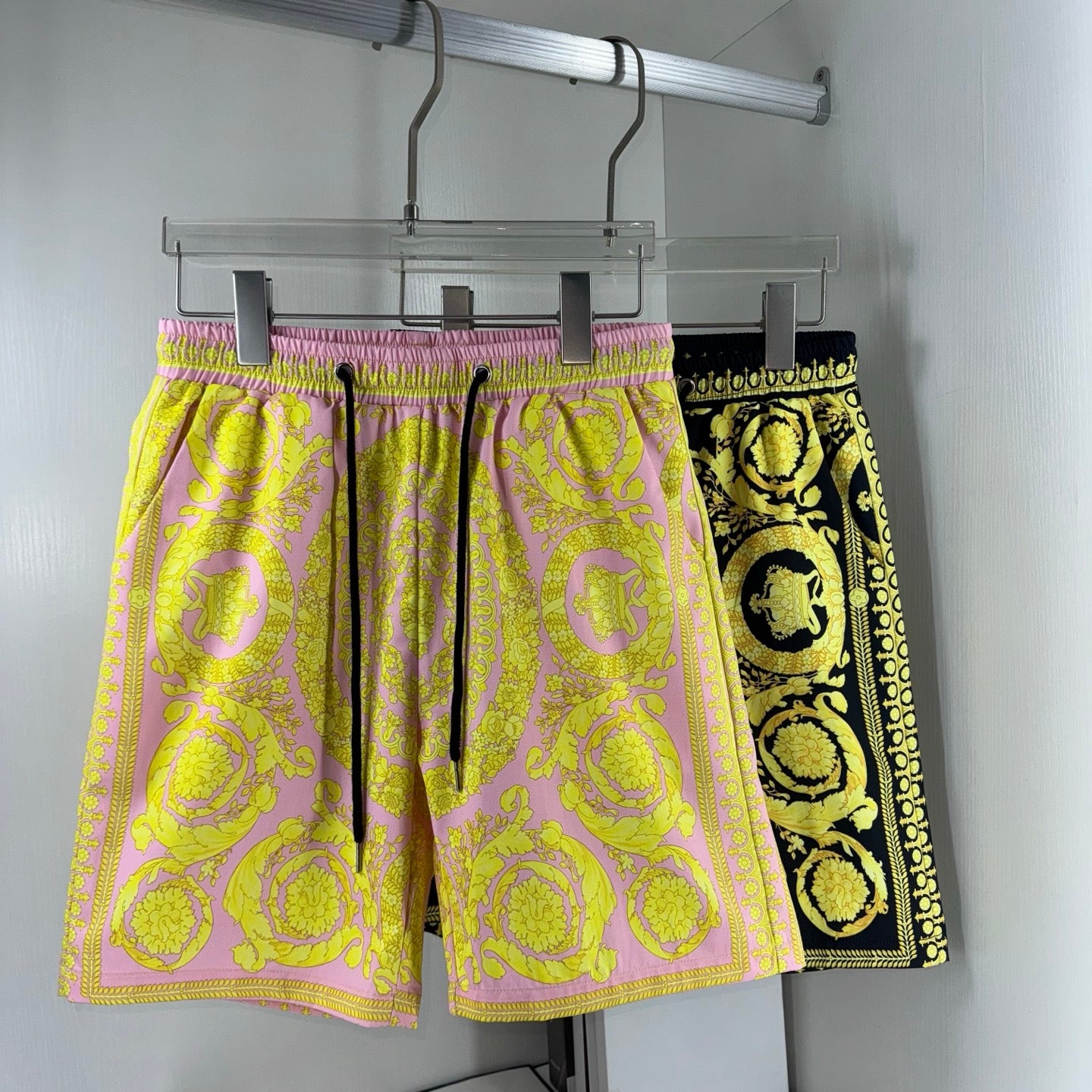 Two-tone printed shorts with elastic waistband and drawstring tie, yellow and black motifs