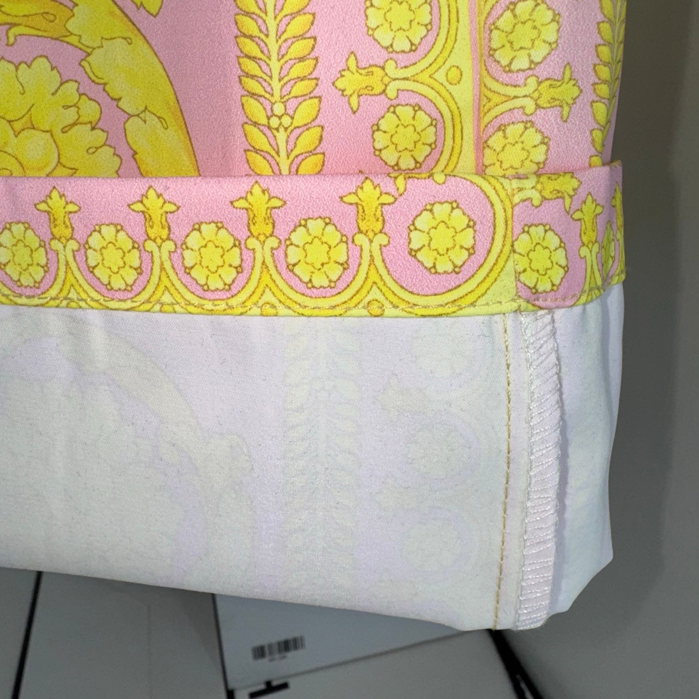 Printed shorts hem with pink border and stitched side seam detail