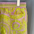 Printed shorts with pink elastic waistband and yellow ornate medallion graphic