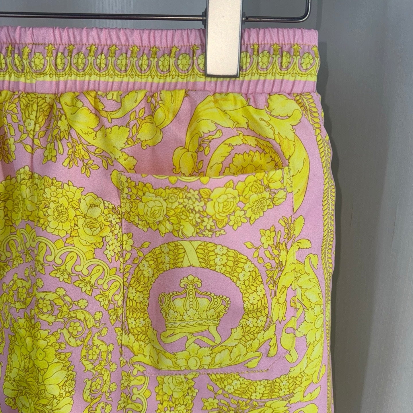 Printed shorts with pink elastic waistband and yellow ornate medallion graphic