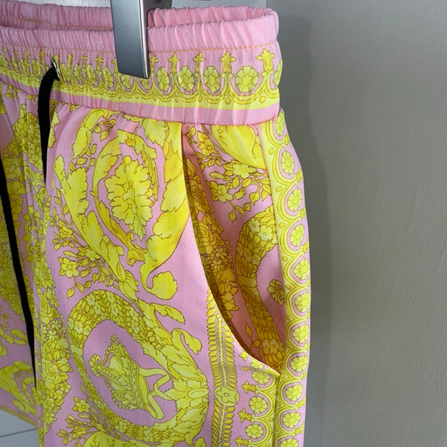 Versace shorts with allover yellow and pink baroque print and elastic waistband.