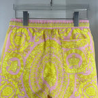 Versace printed shorts with pink elastic waistband and yellow ornate medallion pattern