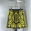 Black and yellow baroque print shorts with drawstring waist and scalloped hem trim