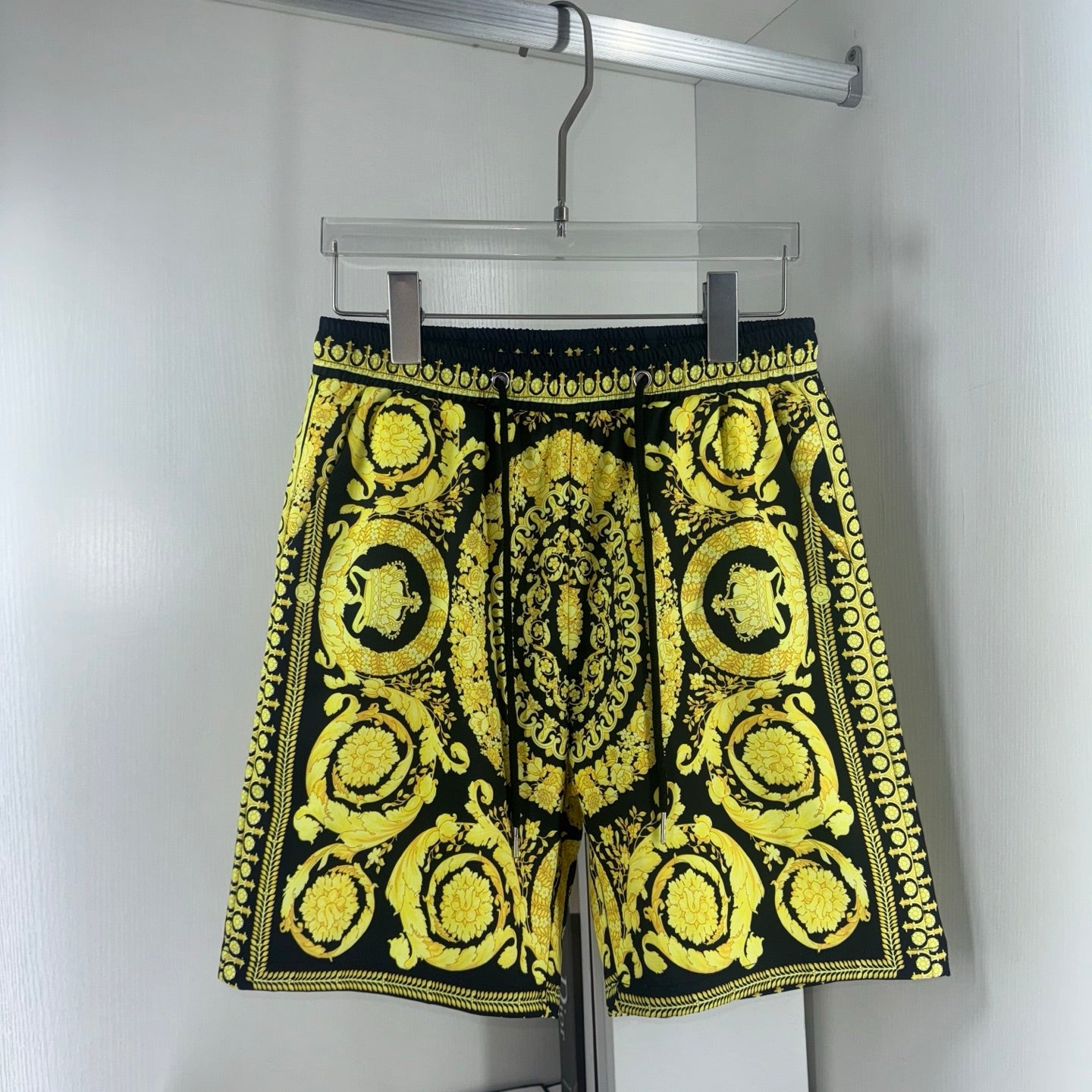 Black and yellow baroque print shorts with drawstring waist and scalloped hem trim