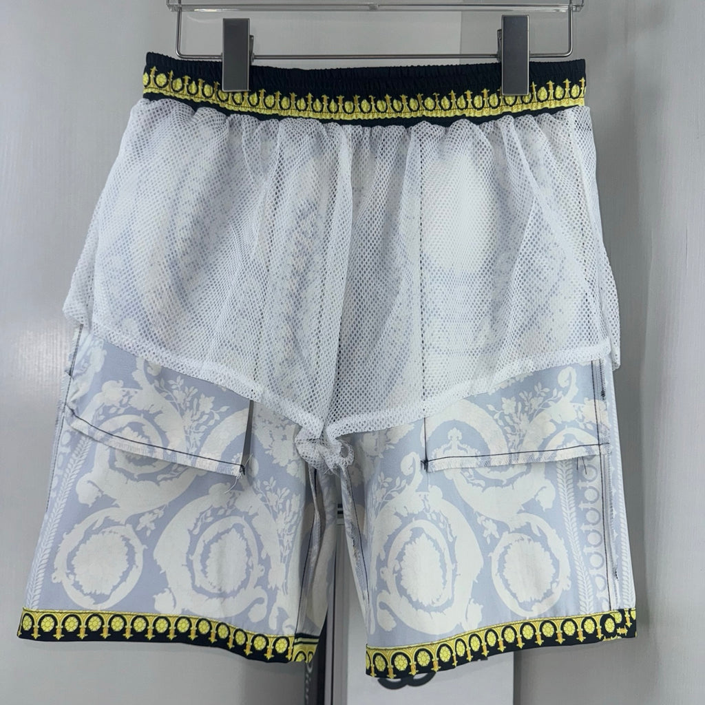 White mesh layered shorts with elastic waistband and pale blue print yoke and cuffs