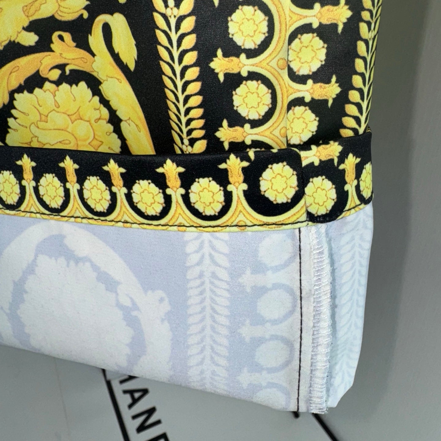 Versace skirt hem with gold-on-dark border and light patterned lining