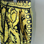Black and yellow baroque print shorts with elastic waistband and decorative border trim