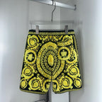 Yellow-and-black baroque print shorts with elastic waistband and drawstring tie