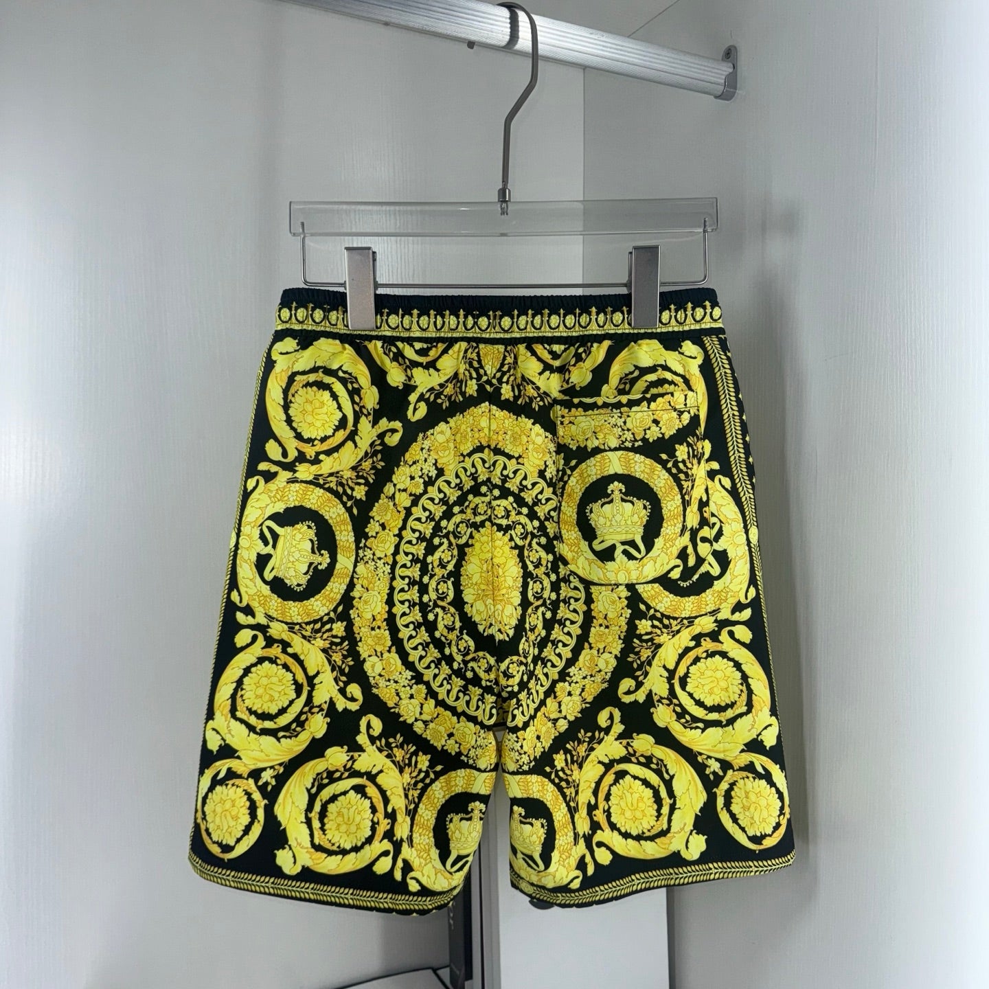 Yellow-and-black baroque print shorts with elastic waistband and drawstring tie