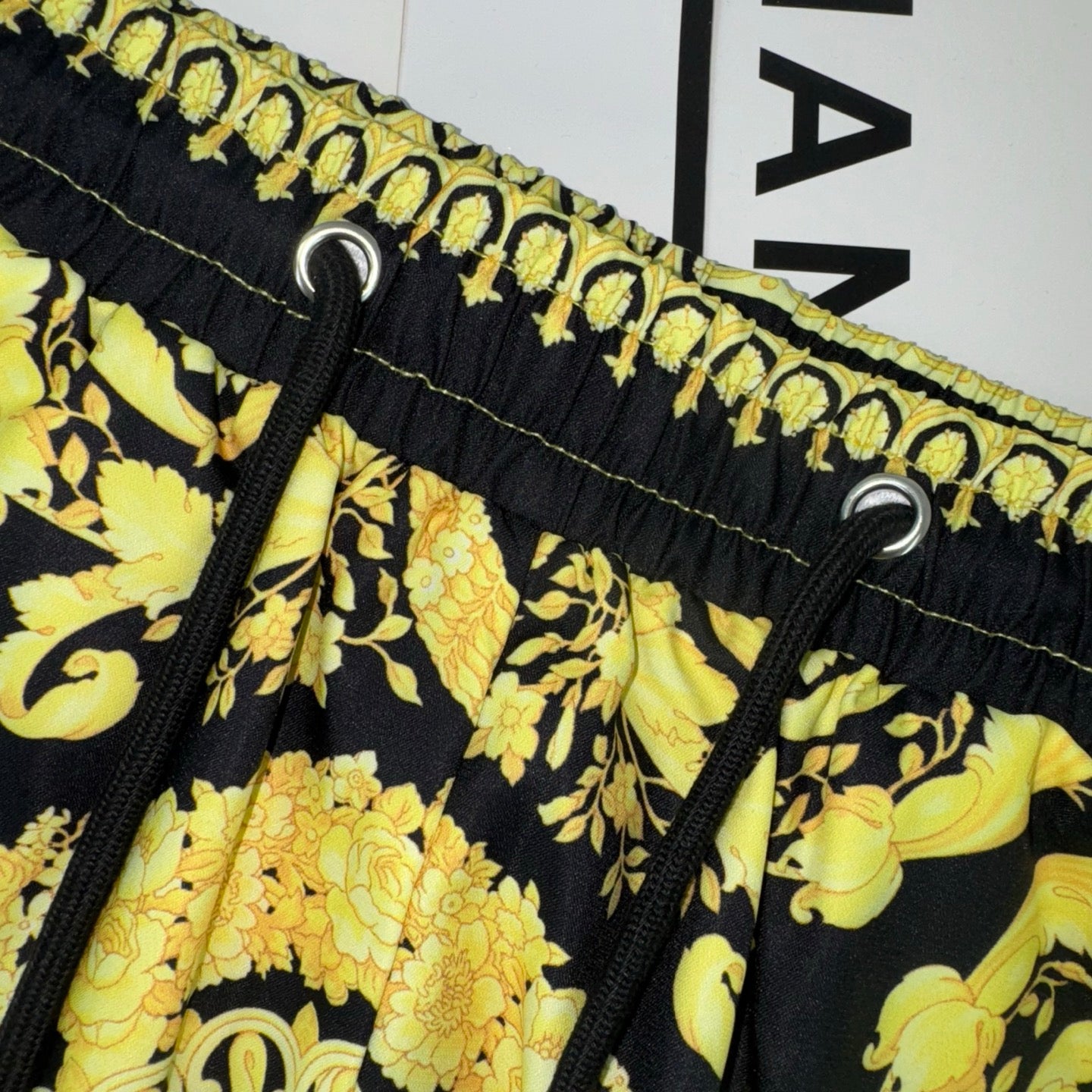Versace skirt waistband with black elastic, gold print, and drawstring eyelets